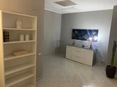 a room with shelves and a desk in it at Giuse home in Palermo