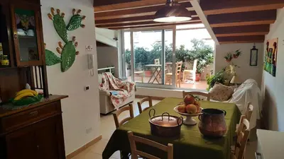 a kitchen and dining room with a table with a green table cloth at PalermiT'Amo in Palermo