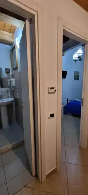 an open door to a bathroom with a sink at PalermiT'Amo in Palermo
