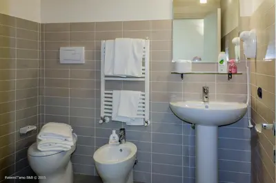 a bathroom with a sink and a toilet and a mirror at PalermiT'Amo in Palermo
