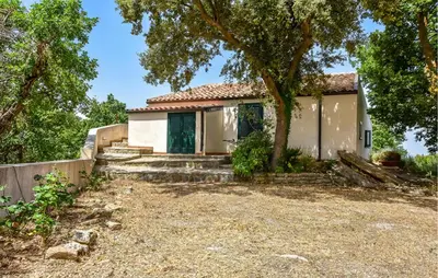 a small white house with a tree in front of it at Pet Friendly Home In Corleone With Wifi in Corleone