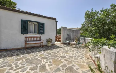 a patio with a bench and a house at Pet Friendly Home In Corleone With Wifi in Corleone