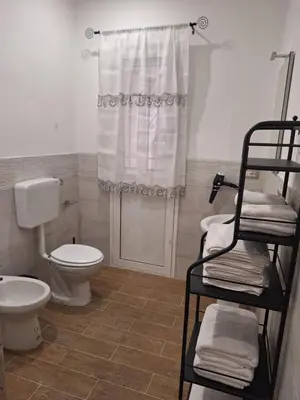 a bathroom with a toilet and a sink and a shower at Casa Sabo Apartment in Palermo
