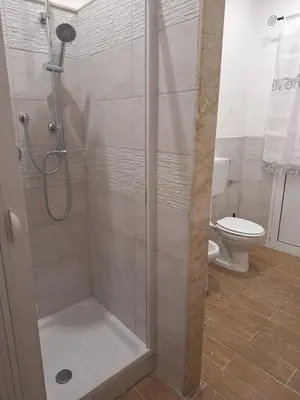 a shower stall in a bathroom with a toilet at Casa Sabo Apartment in Palermo
