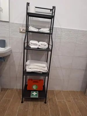 a black towel rack in a bathroom with towels at Casa Sabo Apartment in Palermo