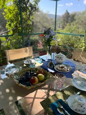 a table with a plate of fruit on it at Splendida Villa immersa nella natura - Villa Salina Trabia in Trabia