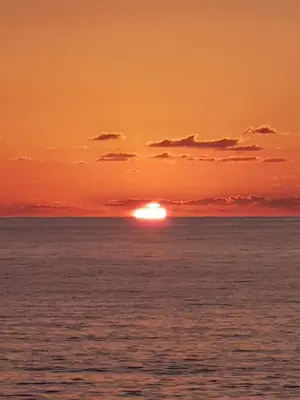 a sunset over the ocean with the sun in the horizon at ai colori di Giggia in Isola delle Femmine