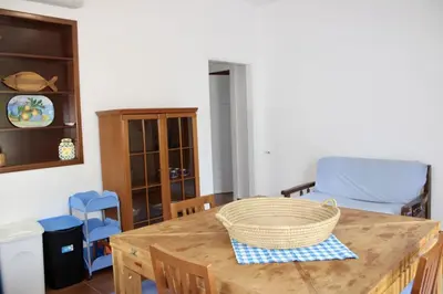 a living room with a television on a cabinet at Gli ulivi di Cala Rossa By Dimora Hub in Terrasini
