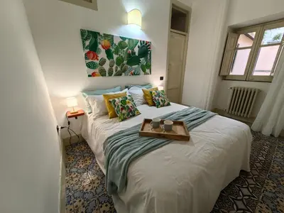 a bedroom with a bed with a tray on it at Centro storico-Marina Free Parking, Wifi,Netflix in Palermo