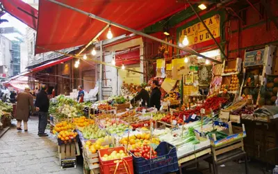 a market with fruits and vegetables on a street at Centro storico-Marina Free Parking, Wifi,Netflix in Palermo