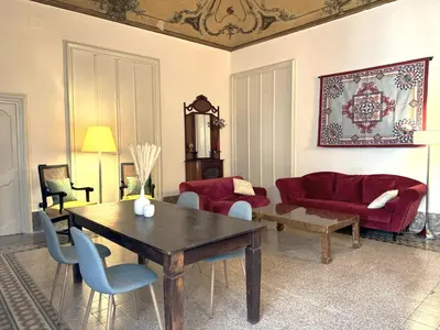a living room with a wooden table and chairs at Centro storico-Marina Free Parking, Wifi,Netflix in Palermo
