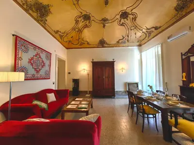 a living room with a red couch and a table at Centro storico-Marina Free Parking, Wifi,Netflix in Palermo