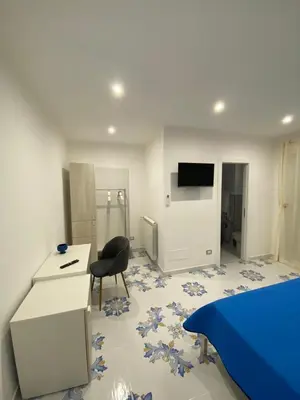 a room with a bed and a desk and a chair at Casa Vacanze dell'Arco - civico 17 in Trabia