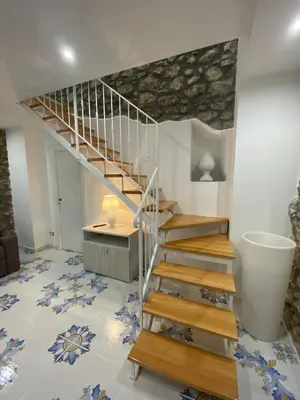 a staircase in a living room with a tile floor at Casa Vacanze dell'Arco - civico 17 in Trabia
