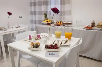 a white table with breakfast foods and drinks on it at Due Passi in Palermo