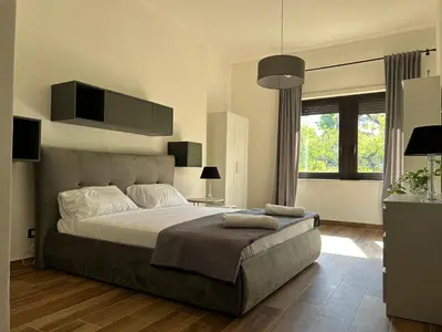 a bedroom with a large bed and a large window at Francys Dreams in Palermo