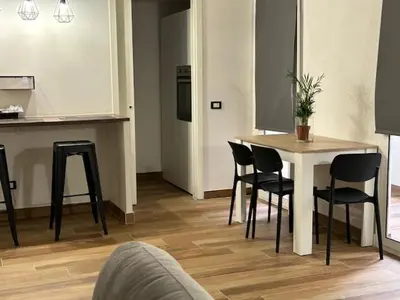 a room with a table and chairs and a kitchen at Francys Dreams in Palermo