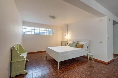 a bedroom with a white bed and a window at Hola House Mondello in Lido di Mondello
