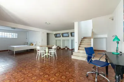 a living room with a table and chairs at Hola House Mondello in Lido di Mondello