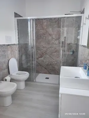 a bathroom with a toilet and a shower and a sink at Tramonti d'Alba in Terrasini