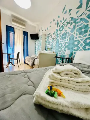 a bedroom with a bed with towels on it at Casa Lilla in Monreale