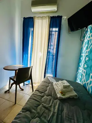 a bedroom with a bed and a table and a chair at Casa Lilla in Monreale