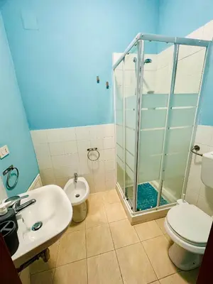 a bathroom with a shower and a toilet and a sink at Casa Lilla in Monreale
