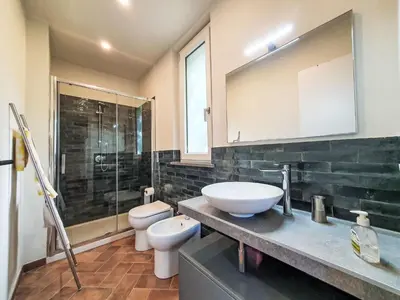 a bathroom with a sink and a toilet and a mirror at Villa Ginestra by Interhome in Piana degli Albanesi