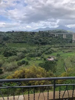a view of a field with a bridge in the background at Nichi & Matti Iemmolo's Guest House in Campofelice di Roccella
