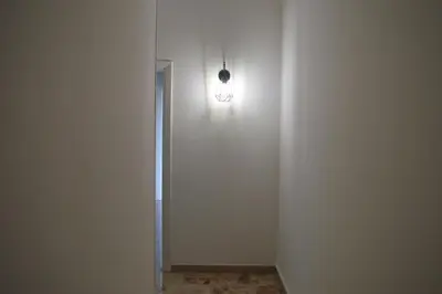 a hallway with a light on a white wall at Casa Amari Bd in Palermo