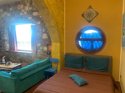 a living room with a couch and a window at Loft Sul Mare in Balestrate