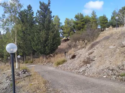a road with a pole on the side of a hill at Rifugio Riserva Grotta Mazzamuto in Altavilla Milicia