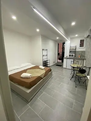 a bedroom with a bed and a table and chairs at Luna di Sicilia in Palermo