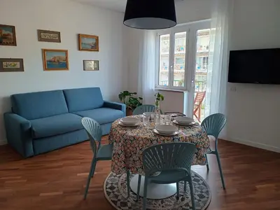 a living room with a table with chairs and a couch at Al Duca appartamento in centro in Palermo