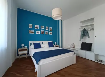 a blue bedroom with a bed and a blue wall at Al Duca appartamento in centro in Palermo