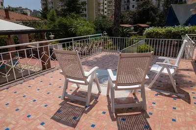 two chairs sitting on top of a brick patio at Oasis Green Villa in Palermo