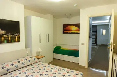 a bedroom with a bed and a door to a balcony at Oasis Green Villa in Palermo