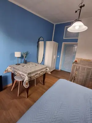 a bedroom with a table and a mirror and a bed at La Casa di Giovy in Palermo