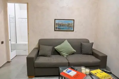 a living room with a couch and a table at Modern apartment center Palermo in Palermo