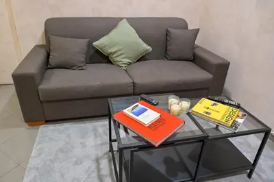 a living room with a couch and a table with a book at Modern apartment center Palermo in Palermo