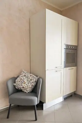 a chair with a pillow sitting in a kitchen at Modern apartment center Palermo in Palermo
