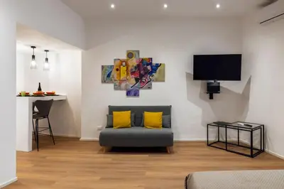 a living room with a couch and a table at Eleven Luxury Suite in Palermo
