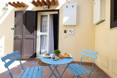 a blue table and chairs on a patio at Maison Zisa - Proppro SRL - Palermo in Palermo