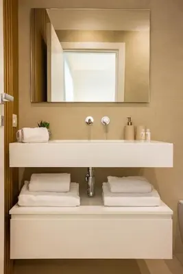 a bathroom with a sink with a mirror and towels at Luxury Villa Leto in Palermo