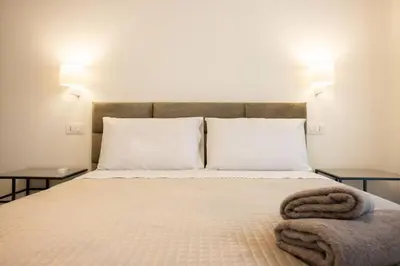 a bedroom with a bed with two night stands at Luxury Villa Artemis Mondello in Palermo