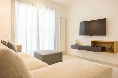 a living room with a couch and a flat screen tv at Luxury Villa Artemis Mondello in Palermo