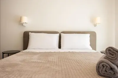 a bed with two pillows and towels on it at Luxury Jacuzzi Villa Diana in Palermo