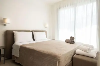 a bedroom with a large bed with towels on it at Luxury Jacuzzi Villa Diana in Palermo