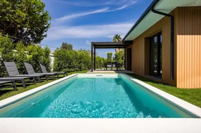 a swimming pool in the backyard of a house at Luxury Jacuzzi Villa Atena in Palermo