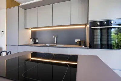 a kitchen with white cabinets and a sink at Luxury Jacuzzi Villa Atena in Palermo